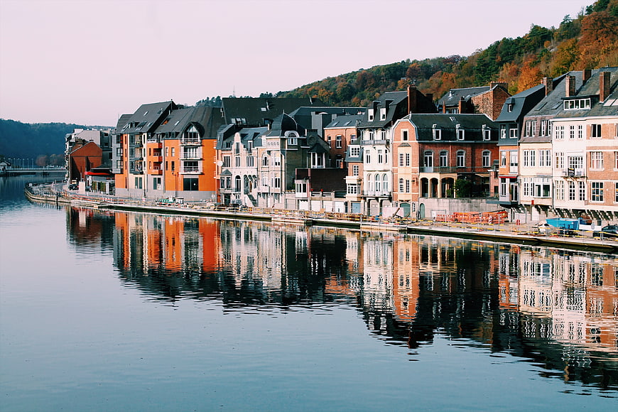 Colorful European waterfront buildings with reflections in calm river