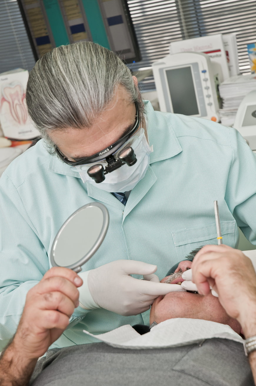 Dentist performing dental procedure on patient