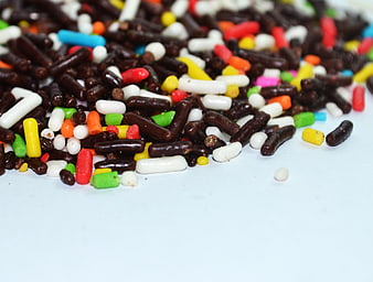 Colorful Candy Sprinkles Scattered On White Surface