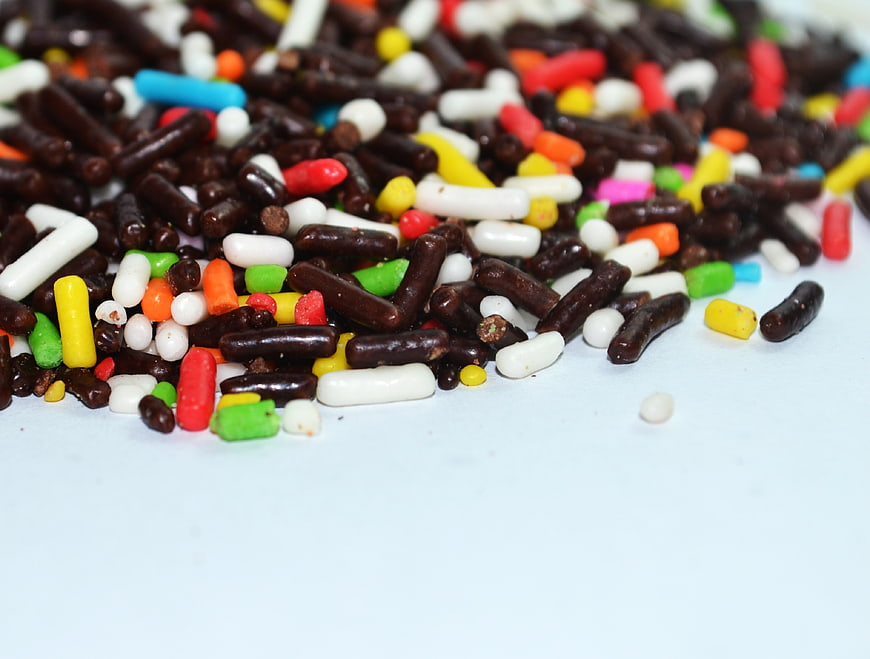Colorful Candy Sprinkles Scattered On White Surface