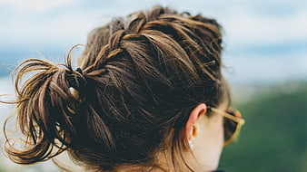 Close-up of woman's braided ponytail hairstyle outdoors
