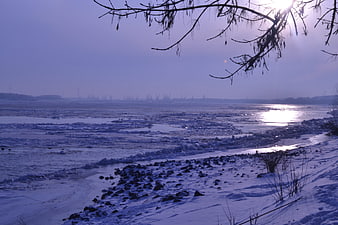 Frozen river landscape with ice floes and winter sunlight