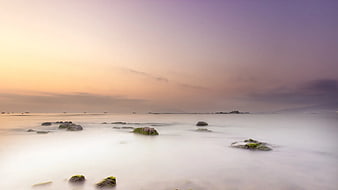 Long Exposure Misty Ocean Sunset with Mossy Rocks
