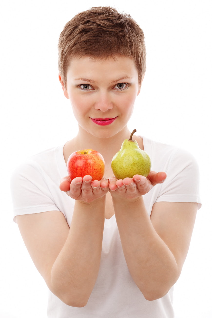 Young Woman Holding Apple and Pear on White Background