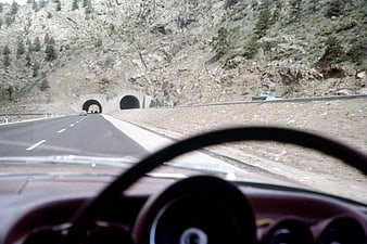 Vintage car dashboard view driving on mountain highway