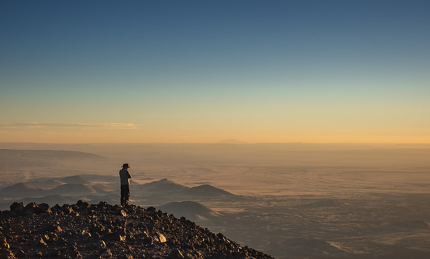 Lone Hiker on Rocky Mountain Summit at Golden Hour