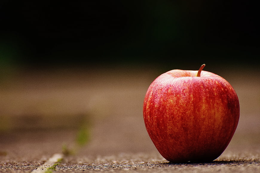 Red Apple on Wooden Surface with Copyspace