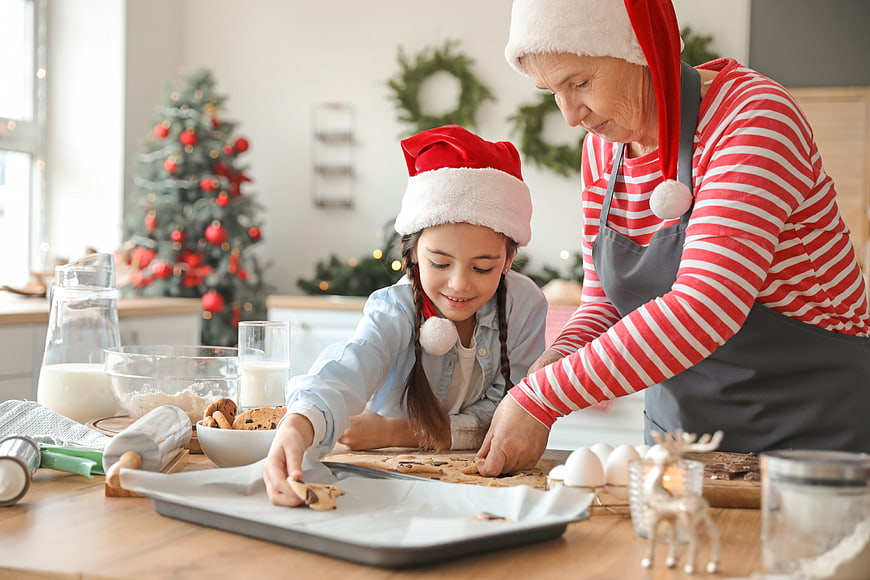 Grandmother and granddaughter baking Christmas cookies together