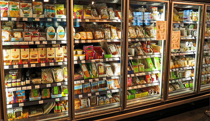 Supermarket refrigerated aisle with packaged food products