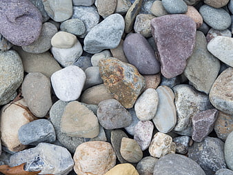 Top view of smooth multicolored river stones and pebbles