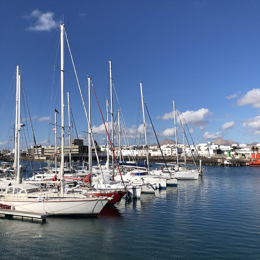 Sailboats docked in a sunny Mediterranean marina