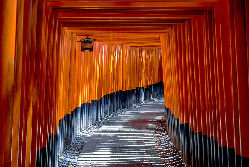 Pathway through red torii gates at Fushimi Inari Shrine