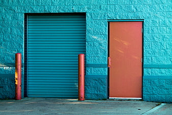 Colorful Teal Brick Wall with Orange Industrial Doors