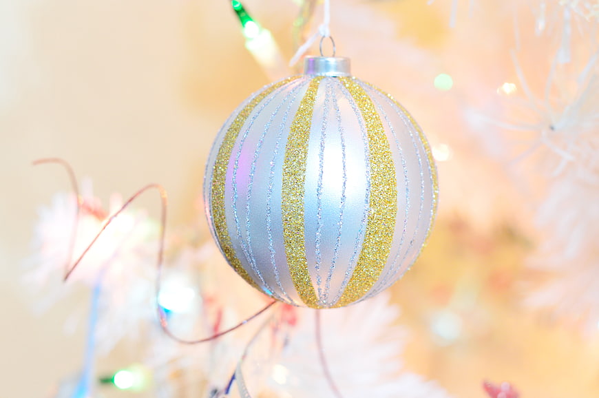 Silver and Gold Glitter Christmas Ornament on White Tree