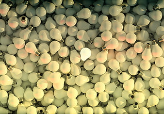 Single glowing light bulb among many unlit bulbs concept