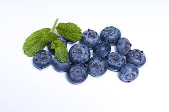 Fresh Blueberries With Mint Leaves On White Background