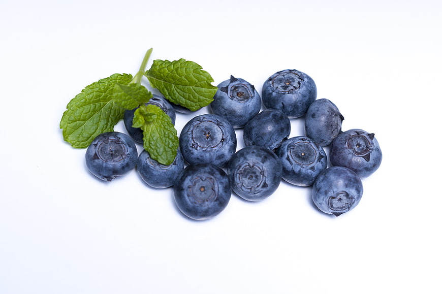 Fresh Blueberries With Mint Leaves On White Background