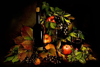 Dark still life with wine bottle, grapes, and apples