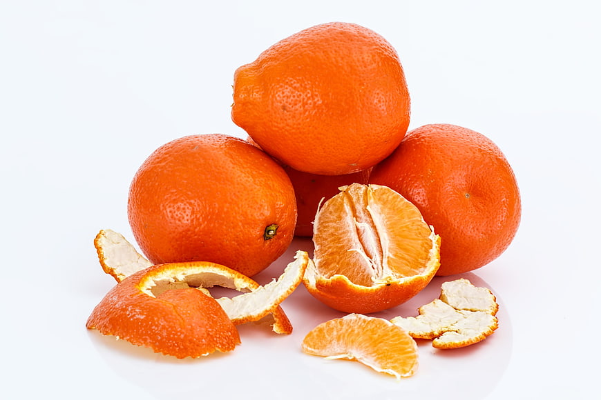 Fresh Minneola Tangelos and Peels on White Background