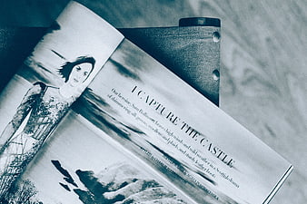 Open fashion magazine with blue monochrome filter on textured surface