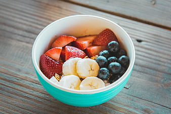 Fresh Fruit Bowl With Strawberries, Bananas, And Blueberries On Wooden Table