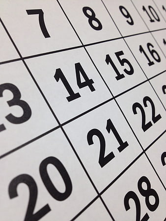 Close-up of calendar grid with black numbers on white paper