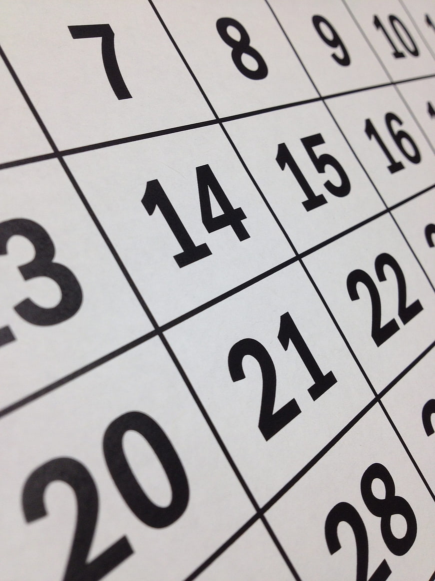 Close-up of calendar grid with black numbers on white paper