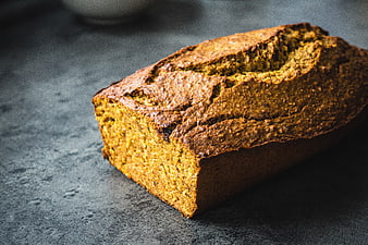 Homemade banana bread loaf on dark textured background