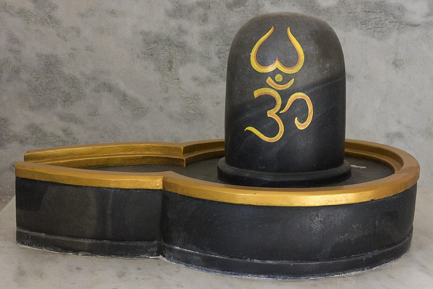 Black stone Shivling with gold Om symbol for Hindu worship