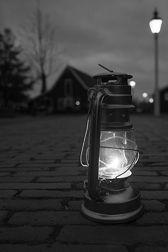 Vintage Lantern on Cobblestone Street at Night