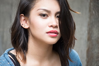 Close-up portrait of young woman with red lipstick