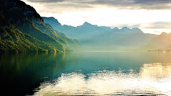 Serene Mountain Lake at Sunrise with Misty Reflections