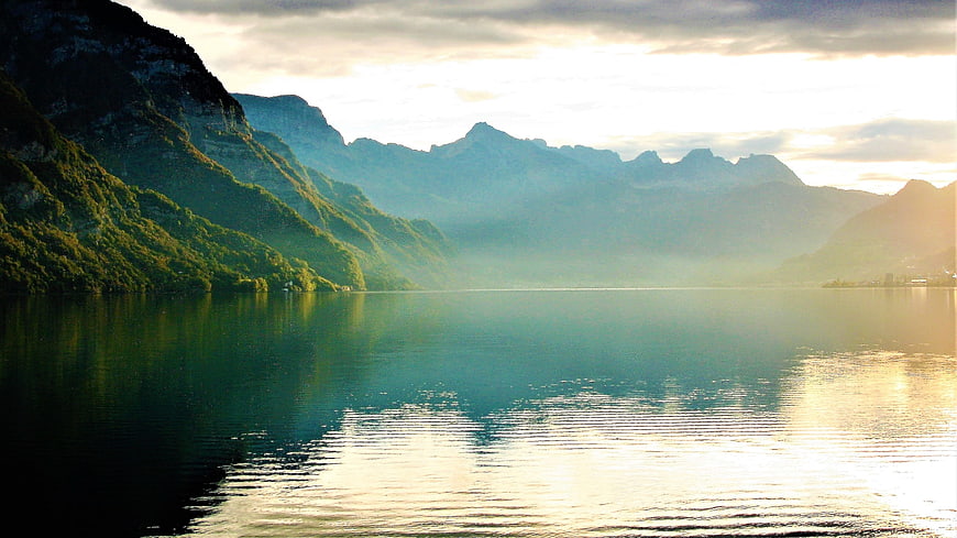Serene Mountain Lake at Sunrise with Misty Reflections