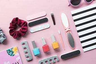 Pink Flat Lay of Manicure Tools, Nail Polish, and Hair Accessories