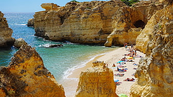 Golden cliffs and turquoise water at a secluded sandy beach