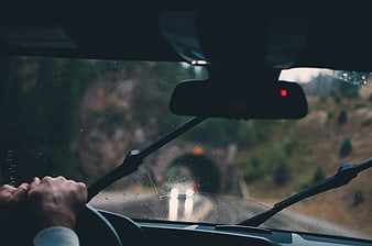 Driver's View Through Rainy Windshield Approaching Tunnel