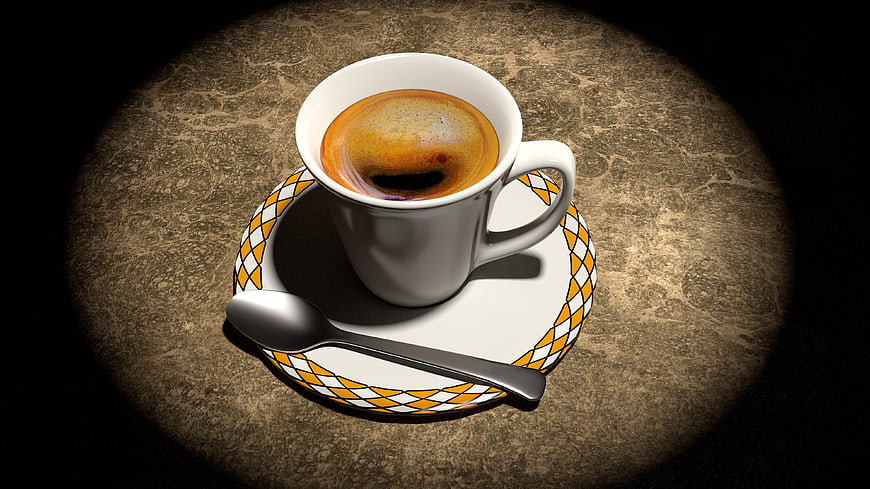 Espresso cup on patterned saucer with spotlight