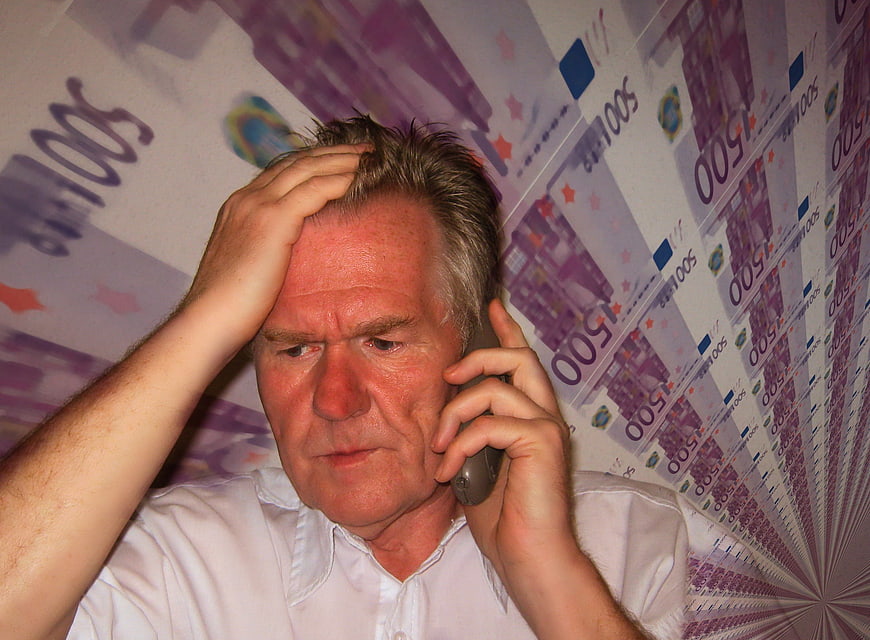 Stressed Senior Man on Phone with Euro Banknote Background