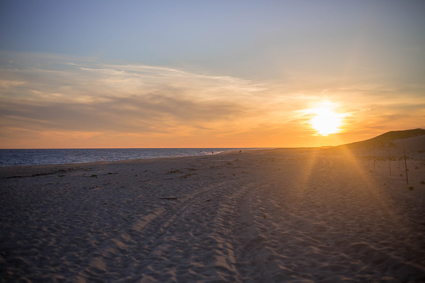 Serene Beach Sunset with Golden Sunlight and Sandy Shore