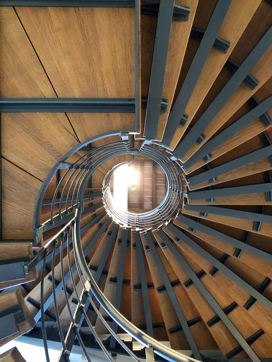 Abstract View of Wooden Spiral Staircase with Metal Railing