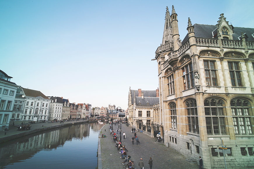 Ghent Graslei canal with historic architecture and tourists