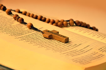 Wooden Jerusalem Cross Rosary on Open Bible