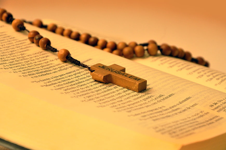 Wooden Jerusalem Cross Rosary on Open Bible