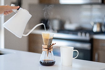Pouring hot water into a Chemex coffee maker