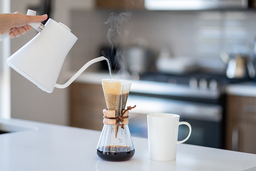 Pouring hot water into a Chemex coffee maker