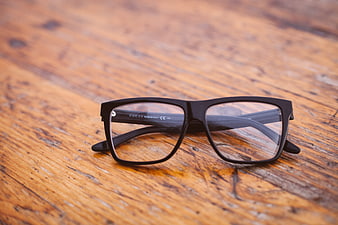 Black Gucci Eyeglasses on Rustic Wooden Table