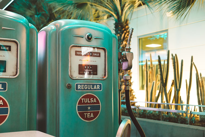 Vintage turquoise Tulsa Tea gas pump with cactus background