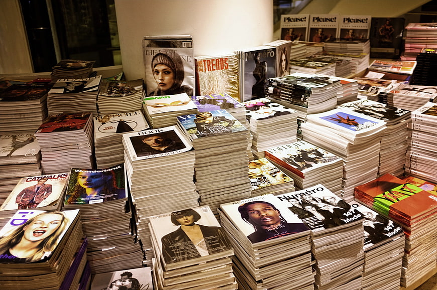 Stacks of fashion magazines and books on display