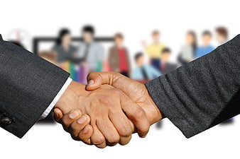 Business Handshake Close-Up With Blurred Office Background