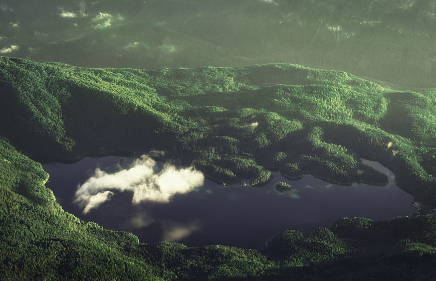 Aerial View of Lush Green Mountain Lake with Cloud Reflection